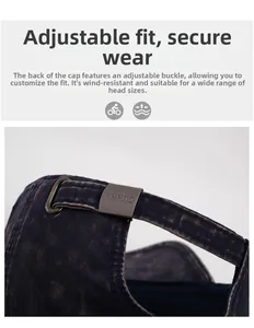Detail of adjustable metal buckle on navy washed denim baseball cap with branded engraving