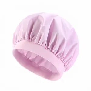 Detail of pink waterproof shower cap featuring a wide elastic band and pleated satin texture
