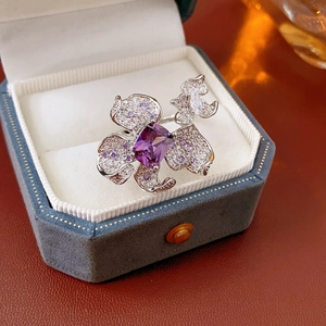 Detail of a purple zircon flower ring on a blue velvet box with sharp metallic luster