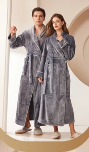 Detailed close-up of thick flannel bathrobe with white contrast piping and soft texture