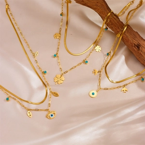 Golden double layer stainless steel necklace with clover, evil eye and swallow charms