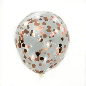 Detailed view of clear latex balloon filled with rose gold round metallic confetti dots
