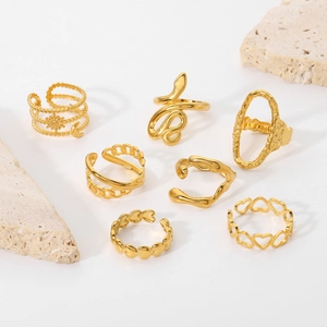 Macro shot of 18K gold plated stainless steel rings set featuring snake and chain designs