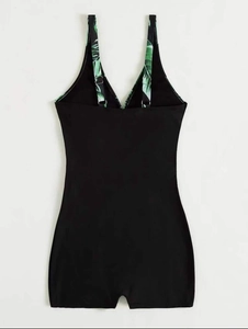Back view of black one-piece swimsuit with tropical leaf print straps and adjustable buckles