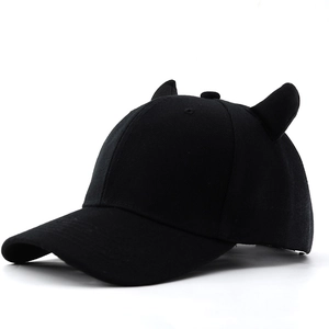 Detail of creative black baseball cap with 3D devil horns and high-quality cotton texture