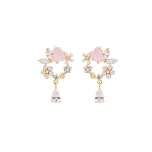 Detail of floral heart drop earrings with pink stones and white flower accents