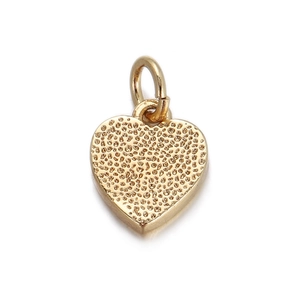 Macro shot of 18K gold plated heart pendant with textured surface and bail