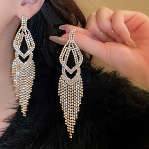 Elegant gold tassel drop earrings with sparkling rhinestones for women on dark background