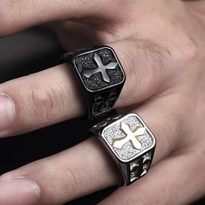 Detail of vintage cross rings with stone texture and matte finish on male hand