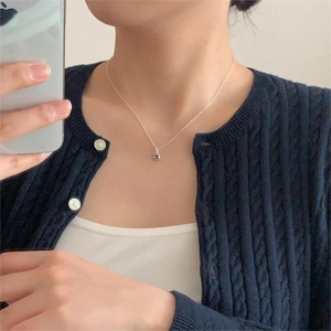 Minimalist silver bead necklace on 925 sterling silver chain shown on model in daily life
