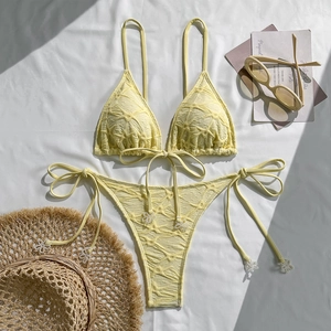Detail of light yellow bikini set with 3D jacquard texture and white floral bead accents