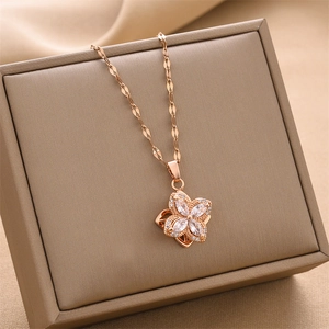 Elegant rose gold rotating clover necklace with marquise zircons on jewelry box