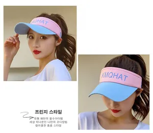 Close-up of pink and light blue color-block sun visor with KMQHAT logo embroidery
