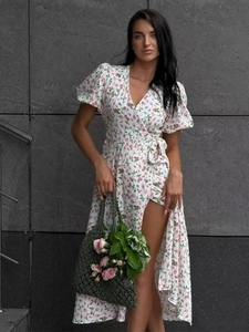 Detail of floral cotton maxi dress featuring puff sleeves and an adjustable waist tie