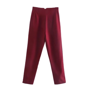 Detail view of burgundy high-waisted trousers with straight-leg cut and tailored waist