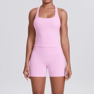 Detailed macro view of pink racerback sports top and high-waist shorts set for gym
