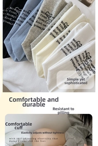 Detail of multi-color crew socks featuring high-elastic ribbed cuffs and letter prints