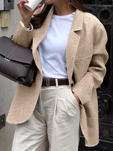 Close-up of premium beige wool blazer for women with refined urban casual aesthetic
