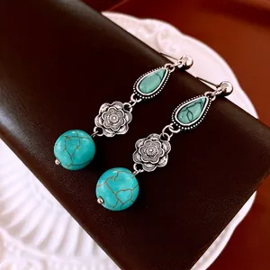 Bohemian silver flower earrings with turquoise teardrop stones in a retro ethnic style