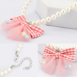 Elegant pet pearl necklace with a pink plaid bow and adjustable silver lobster clasp