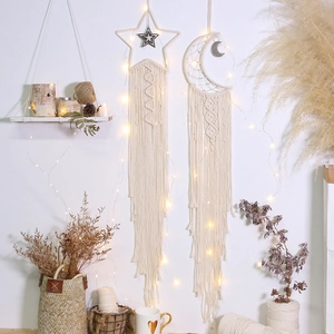Detailed handmade macrame wall hangings in star and moon shapes with warm LED fairy lights