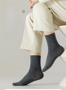 Detail of dark gray cotton mid-calf sock showing fine knit texture and elastic cuff