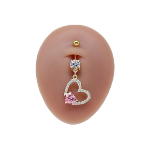 Detail of pink heart navel ring with gold finish and white zircons on silicone model