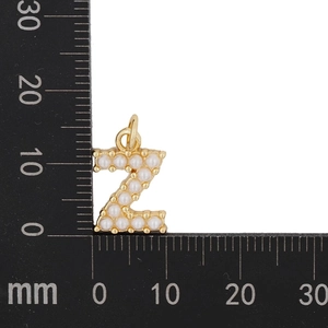 Macro shot of gold letter Z pendant with pearls on scale ruler showing 17mm size