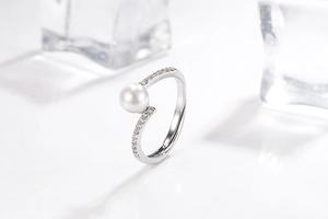 Detail of S925 sterling silver ring with white pearl and shimmering zircon stones