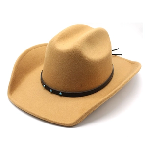 Close-up of wide brim camel wool fedora hat with turquoise beaded leather band