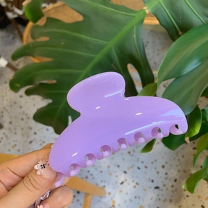 Close-up of large lavender purple resin hair claw clip with smooth matte finish