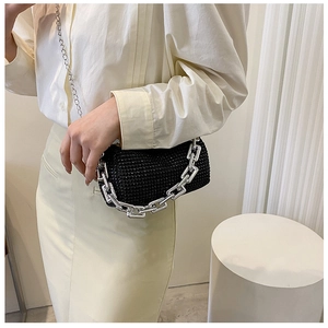 Detail of black rhinestone pillow bag with chunky silver chain and metallic shoulder strap