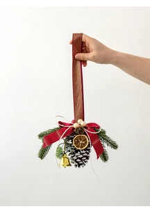 Christmas pine cone ornament with red bow, golden bells, and faux needles detail