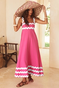 Detail view of pink maxi dress featuring white scalloped edges and cotton linen texture