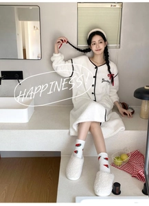 Detail of soft white coral fleece loungewear with Goodday embroidery and strawberry socks