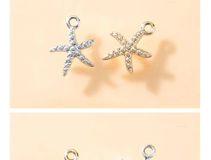 Detail of starfish pendants in gold and silver finish with textured metal surface