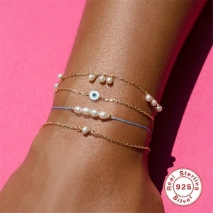Set of four S925 sterling silver evil eye and pearl bracelets with golden chains and blue cord