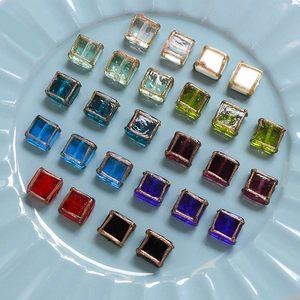 Close-up of square glass beads with gold edges for DIY jewelry making accessories