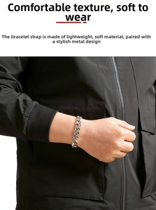 Close-up of a chunky silver stainless steel Cuban link chain bracelet on a male wrist