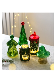 Detailed view of glowing mini Christmas tree lights and glass angel lanterns set