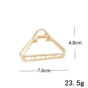 Detailed view of golden triangle hair claw clip with dimensions 7.6cm by 4.8cm