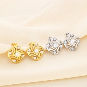 Elegant 18K gold and silver shell pearl flower stud earrings on white silk