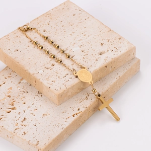 Minimalist gold stainless steel beaded bracelet with religious medal and cross pendant