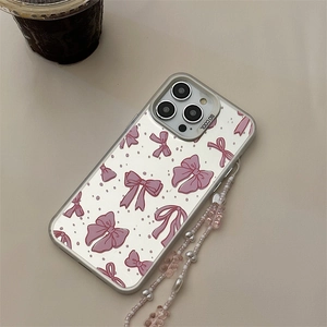 Close-up of clear phone case with pink bow pattern and beaded wrist strap for iPhone