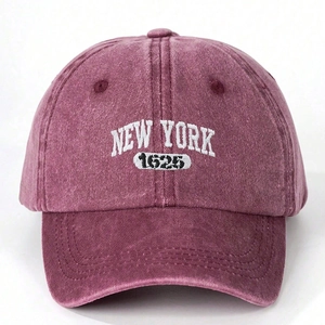 Detailed view of white New York 1625 embroidery on a washed burgundy baseball cap