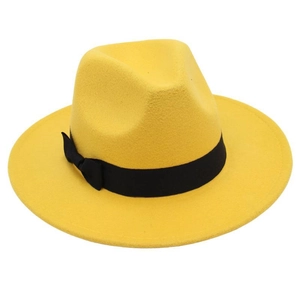 Detail of a bright yellow wool fedora hat with a black velvet ribbon and bow accent