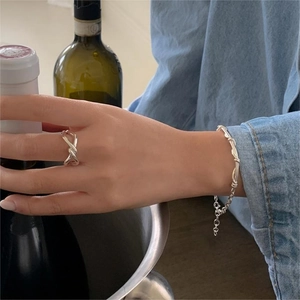 Elegant 925 sterling silver knotted ring and slim bracelet set on model hand