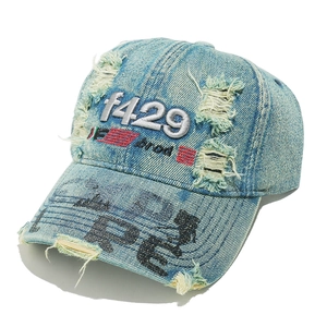 Close-up of vintage washed denim baseball cap with distressed details and f429 embroidery