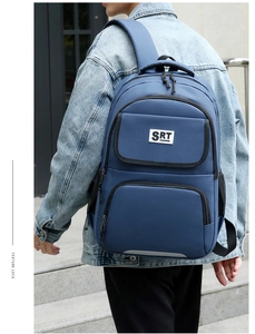 Blue nylon business backpack with SRT logo shown on person for outdoor travel