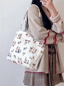 Close-up of quilted cotton tote bag with colorful bunny prints and sturdy shoulder strap